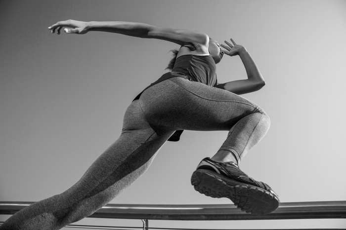 A person mid stride, sprinting